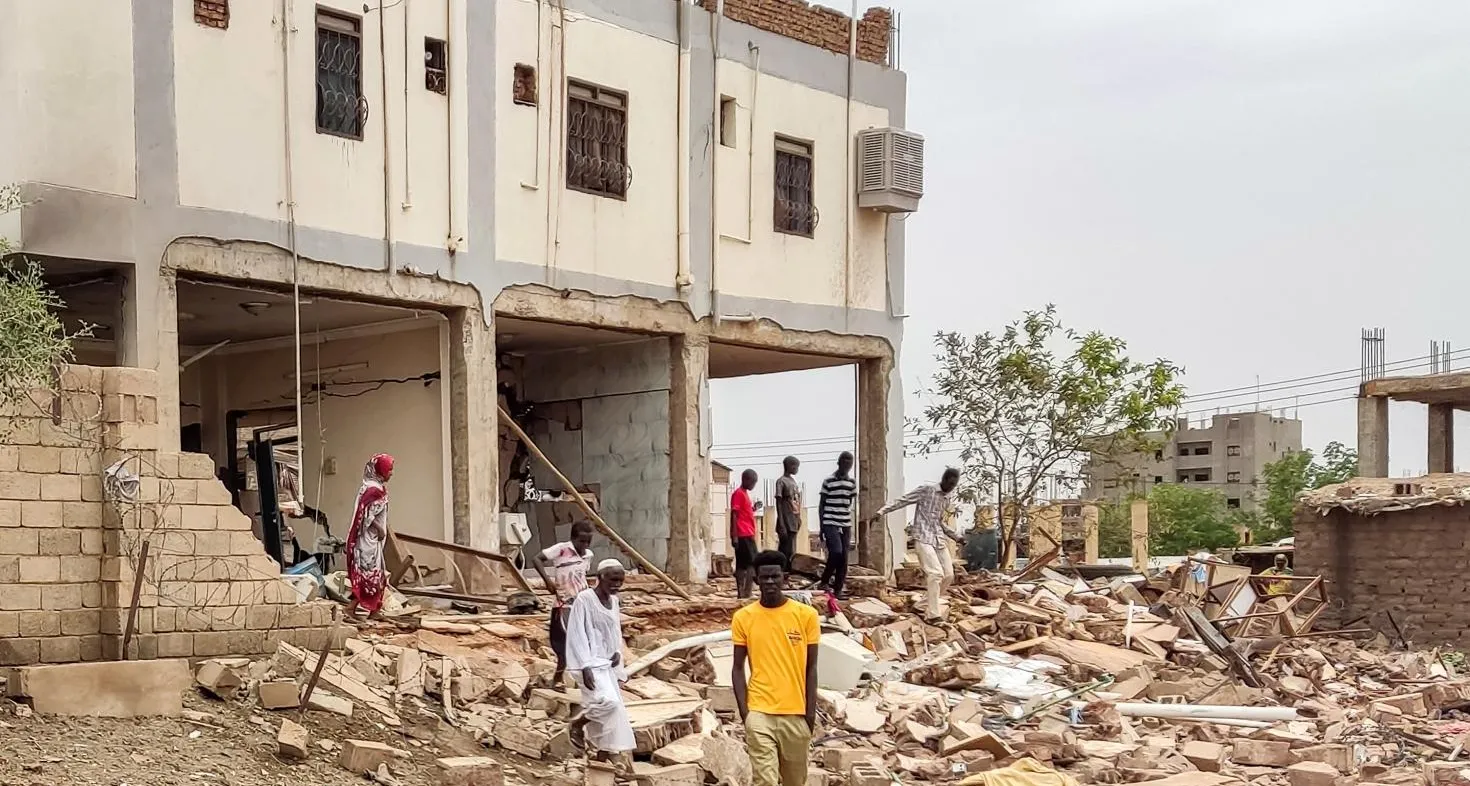 People at a house that was hit by an artillery shell in the south of Khartoum on June 6, 2023 - AFP