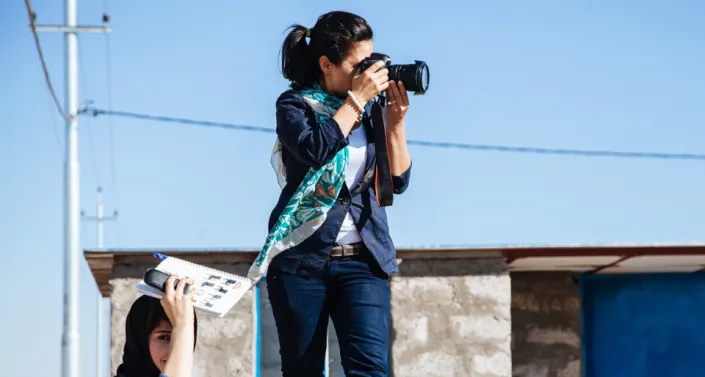 Photojournalist takes a picture in Iraq.