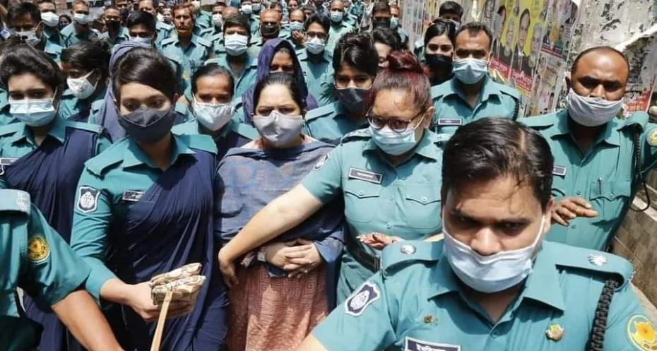 Rozina Islam surrounded by police officers.